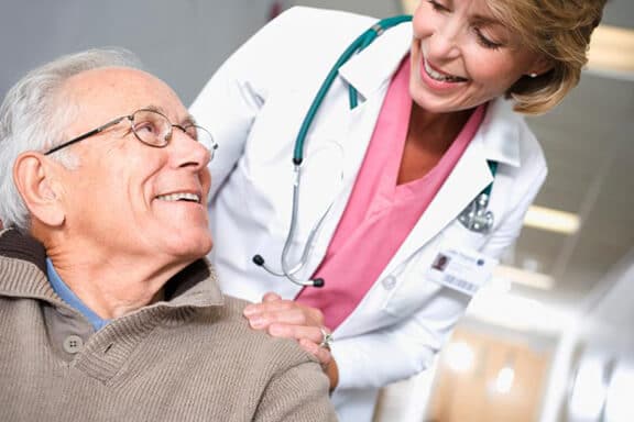 older man visiting female geriatrician