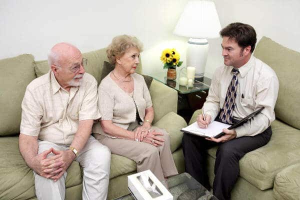 An elder care consultant meeting with a senior couple.