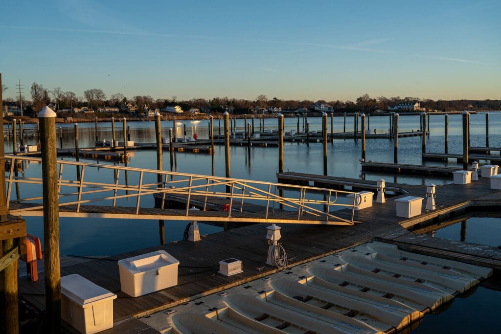 Red Bank, NJ, USA -- The early morning glow of sunlight spilling over a pier on the Navasink River